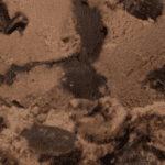 Chocolate ice cream with dark chunks.
